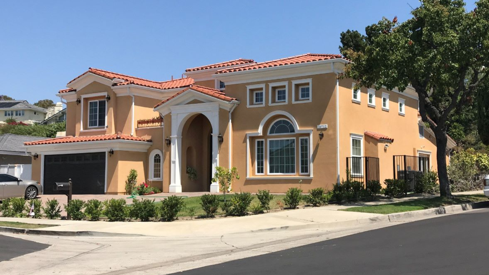 Completed luxury home exterior at dusk by Newport Construction Group