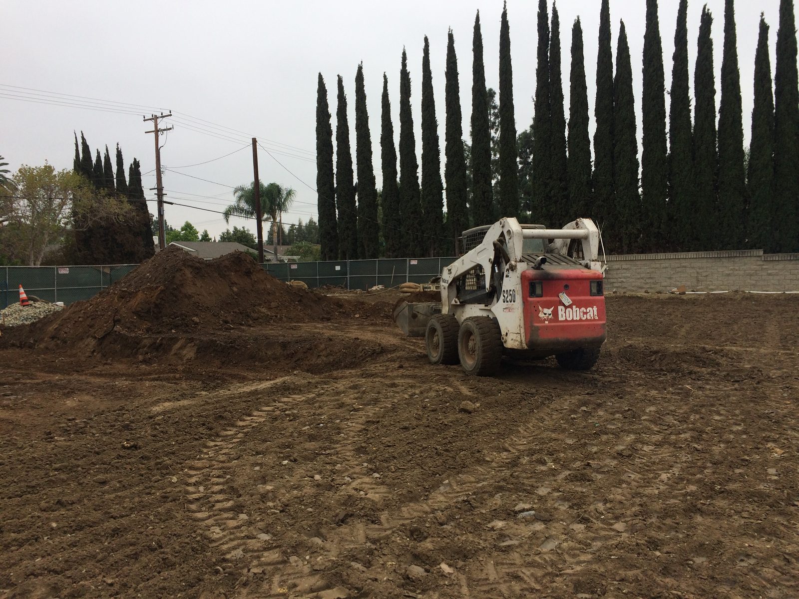 Lot clearing and earthmoving equipment on a custom home site by Newport Construction Group