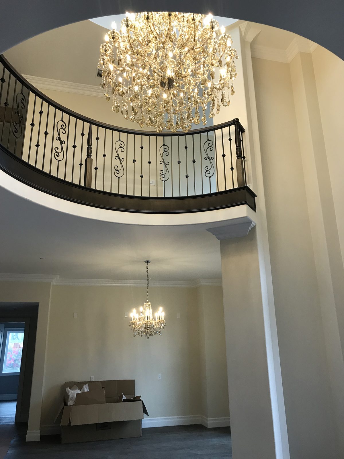 Grand entryway featuring a custom crystal chandelier and rotunda landing by Newport Construction Group