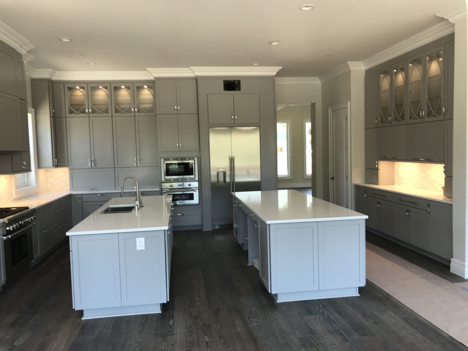Custom luxury kitchen with dual islands and custom cabinetry built by Newport Construction Group