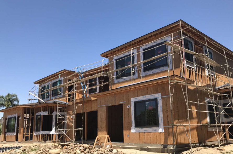 Rear elevation structural framing and window installation by Newport Construction Group in Villa Park